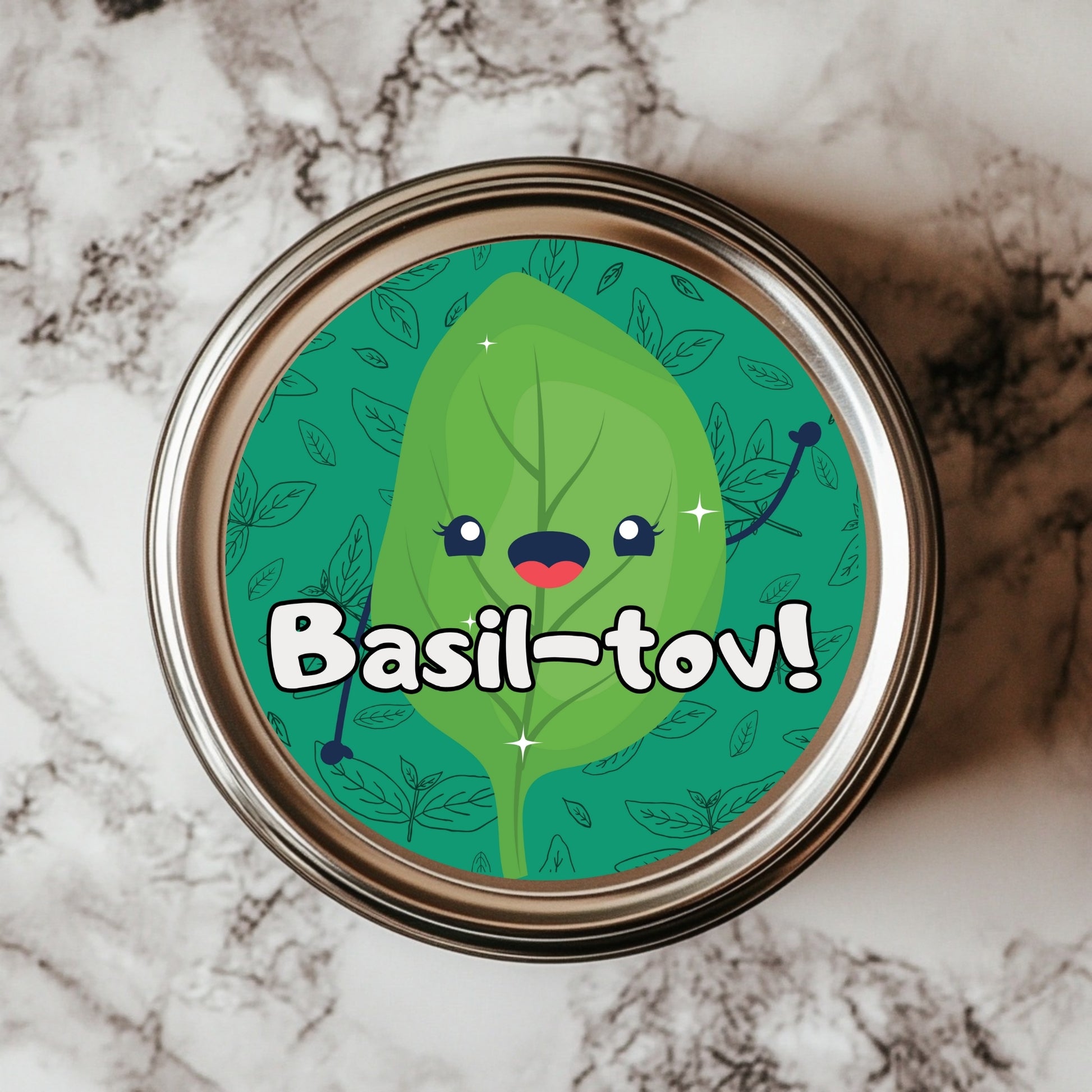 A round sticker with a smiling basil leaf design, featuring the text 'Basil-tov!' surrounded by a pattern of leaves on a green background.