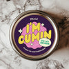 A round sticker with bold typography and vibrant colors, featuring the phrase 'I'm Cumin to My Senses' in yellow and pink on a purple background, designed for use on spice jars or as a quirky gift tag.