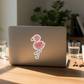 Flamingo sticker on MacBook, desk flat lay
